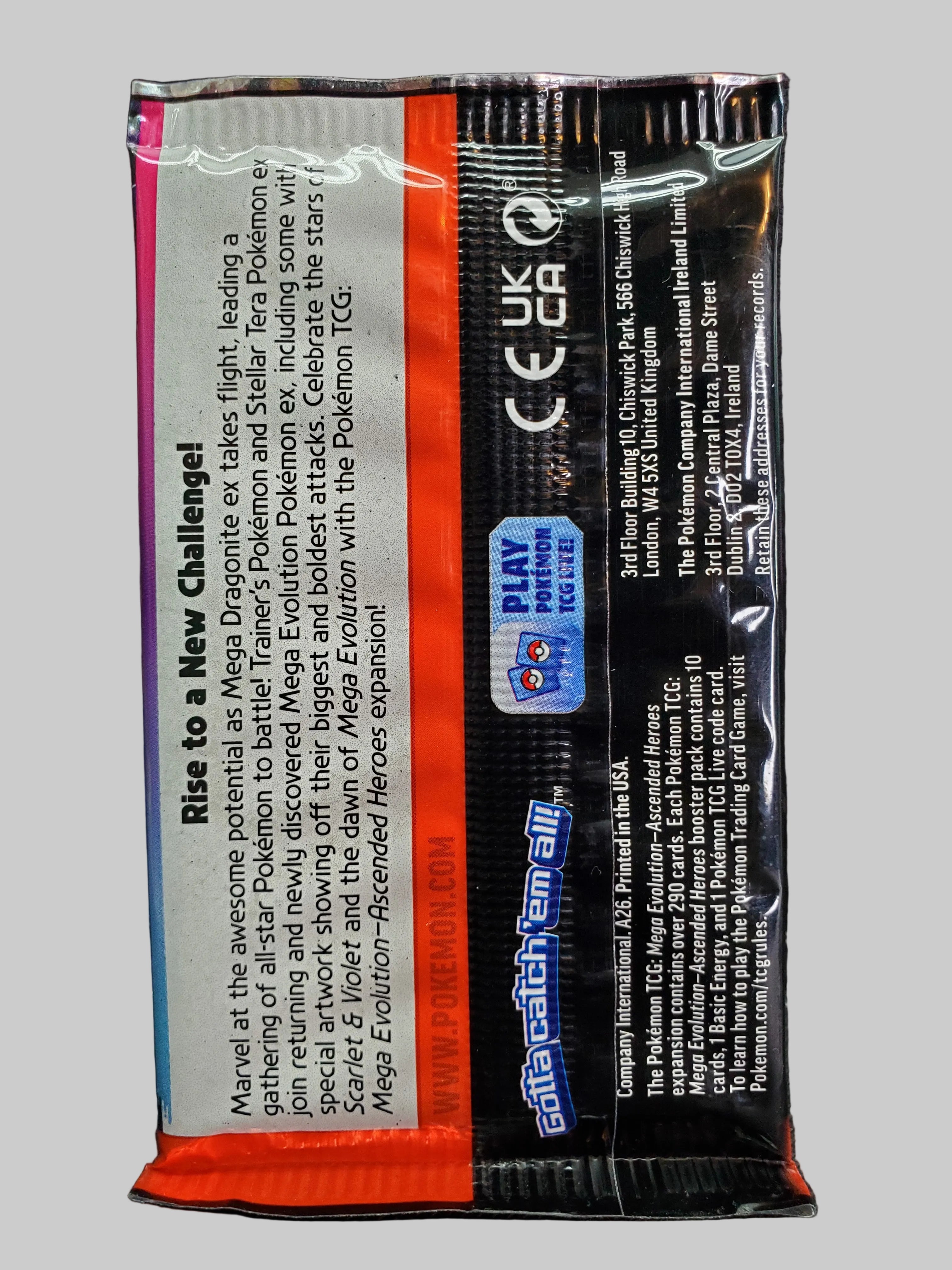 A sealed Pokémon TCG trading card pack from the Rise to a New Challenge set, showing the back of the packaging with product details, a Play Pokémon 2025 logo, and a Catch 'em All sticker area, photographed on a dark textured surface.