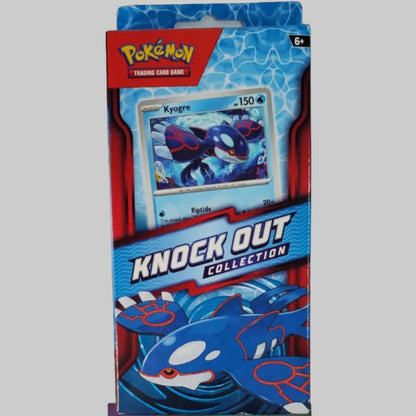 A Pokémon Knock Out Collection trading card booster pack box standing upright on a white surface. The packaging features blue and red graphics with a card illustration of Regirock and Pokémon branding at the top.