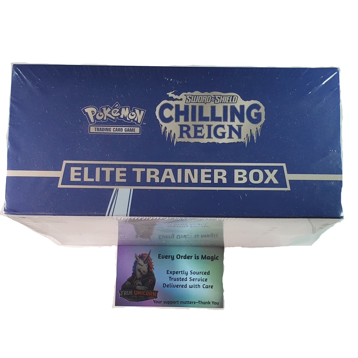 A sealed blue Pokémon Chilling Reign Elite Trainer Box sits on a white desk 