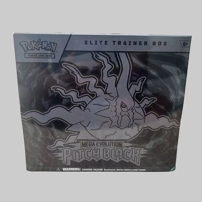 A sealed Pokémon Elite Trainer Box for Mega Evolution Pitch Black, shown in its original packaging on a light wood tabletop with a blurred indoor background.