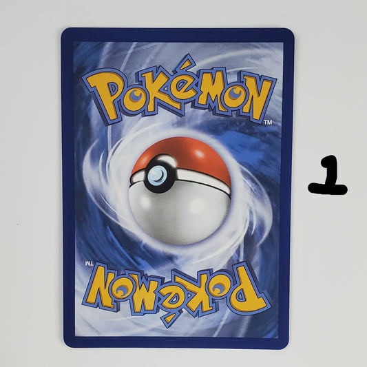 A Pokémon trading card featuring the classic red and white ball design on a blue swirling background, with the yellow 'Pokémon' logo at the top and mirrored logo at the bottom, photographed against a plain white wall.
