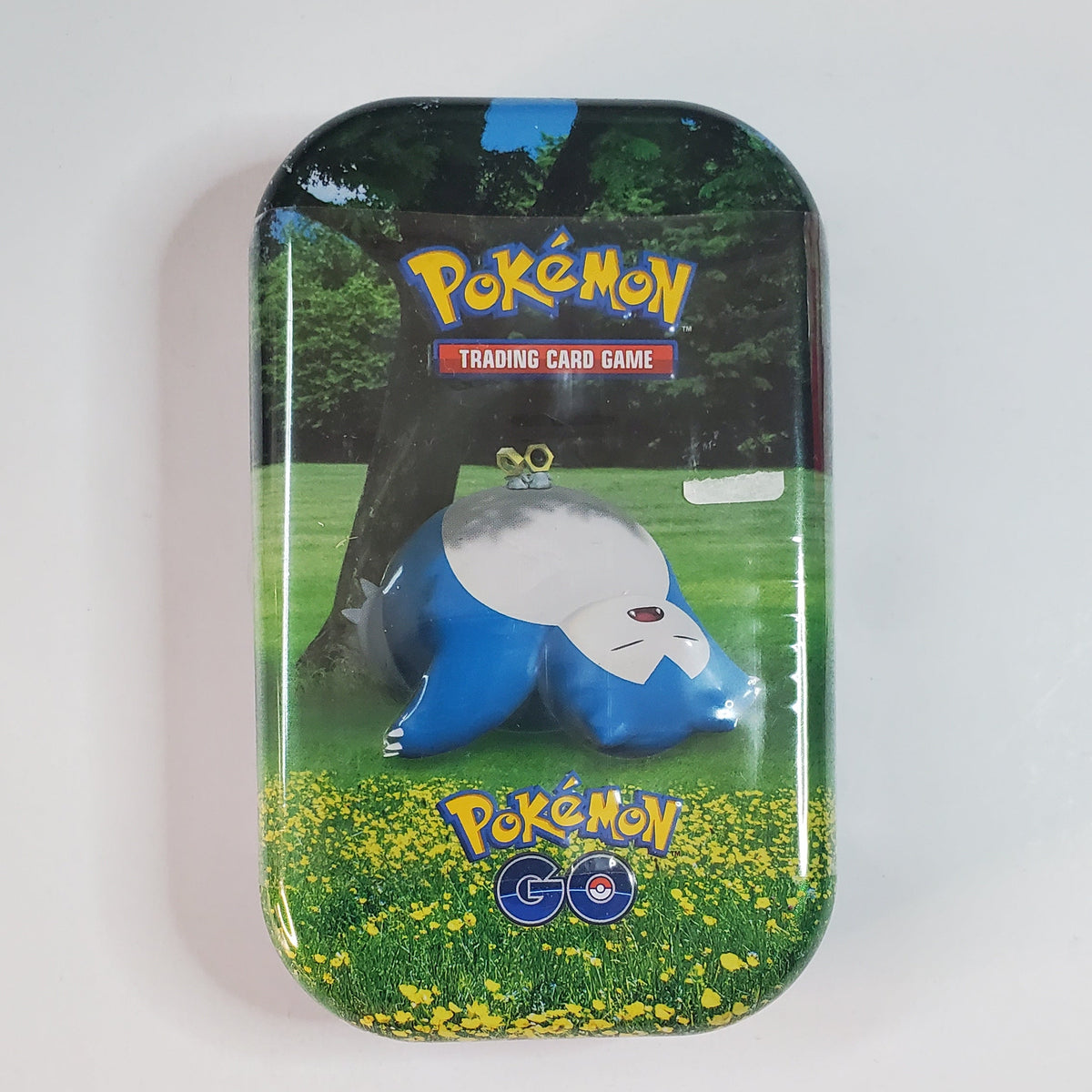A sealed Pokémon Trading Card Game tin featuring a blue and white Clobbog character on the front, photographed against a plain white background.