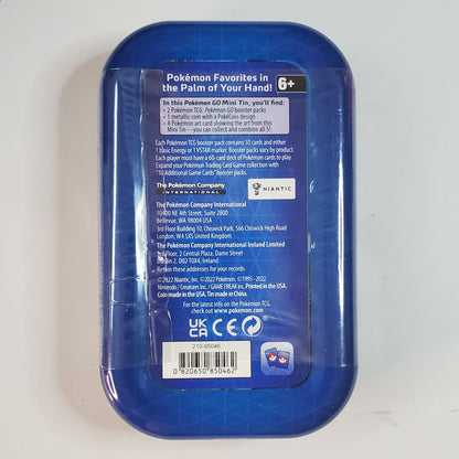The back of a blue plastic container with a clear plastic wrap, featuring product information labels, photographed on a light gray background.