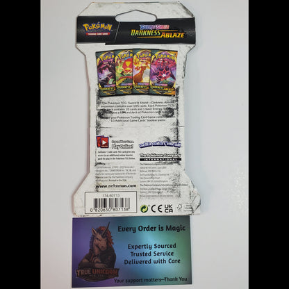 Back of a Pokémon TCG card pack package, showing the product reverse side with card art, text, barcode, and a separate branded insert card below on a white background.