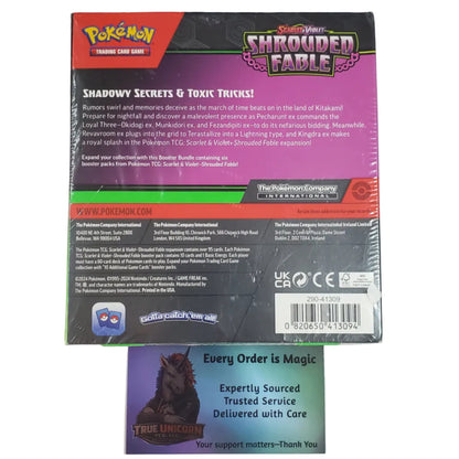 The back of a Pokémon TCG shrink-wrapped card pack for Shroud of Fable is shown on a light gray background, with a small support card placed in front.